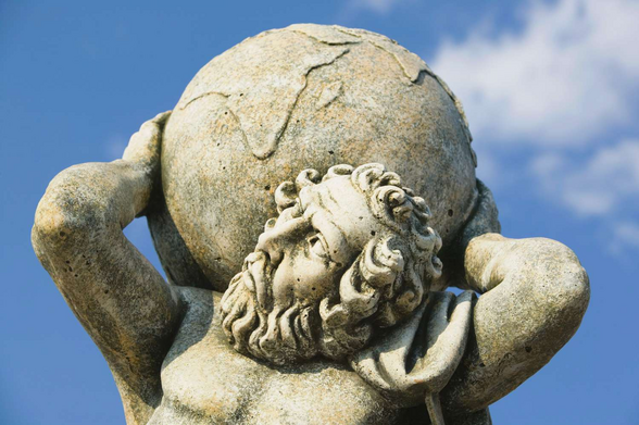 photo of a statue of the Greek mythological figure Titan holding the earth on his shoulders