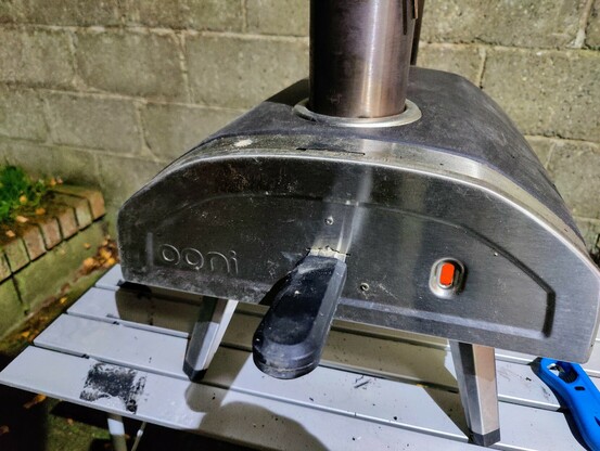 Portable pizza oven on a table in the garden