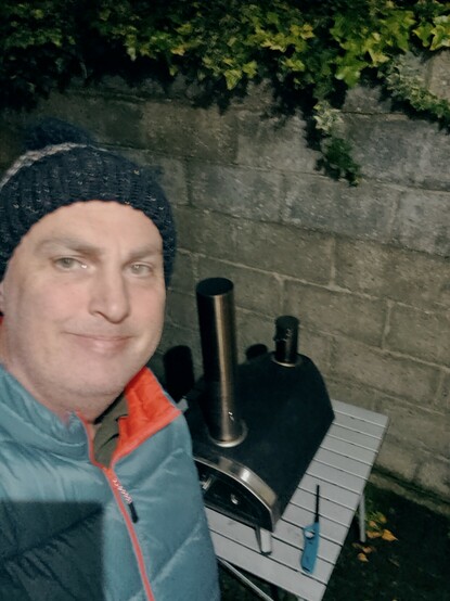 Selfie taken in front of a portable pizza oven