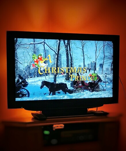 Photograph of a television with the title card for "A Christmas Prince" on the screen. And I'd do it again. Only god can judge me.
