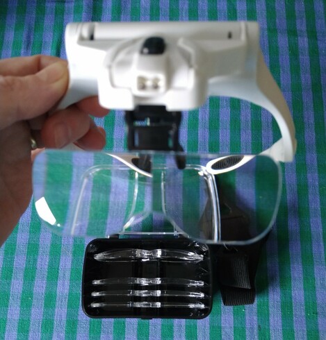 The magnifying headset with a collection of lenses.