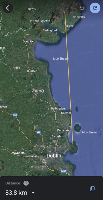 A map showing a portion of the east coast of Ireland, from Dublin to Co. Down, with a line indicating view the photograph takes in. At the bottom, the distance to the far away mountains is indicated as 83.8km