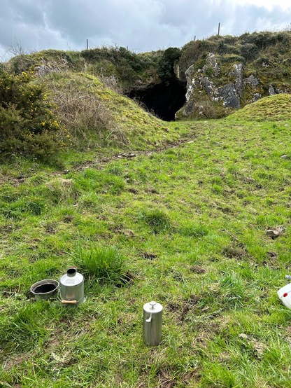 First coffee break on cave site day 1, Kelly kettle used to boil water and metal large French press for coffee brewing.