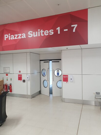 A pair of double doors with Piazza Suites 1-7 on a big banner above it.