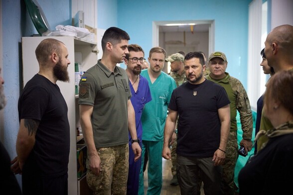 President Zelensky touring a medial ward surrounded by medics
