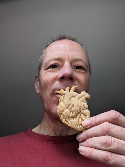 Me about to eat a shortbread biscuit in the shape of an anatomical heart