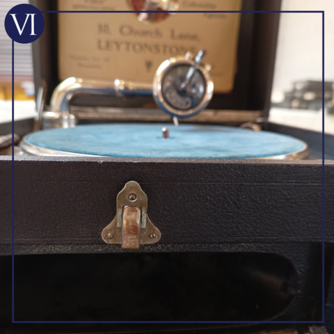 Close-up at turntable level that gives more an impression of the object than any details, but the colours are quite nice as the external part of the gramophone is black while the turntable platter is covered with a soft, blue fabric, almost velvety in texture, and the gleam of the large, old-fashioned, metal stylus arm can also be seen.