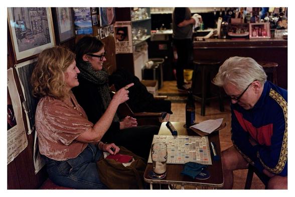 Fiona, Muireann & Ted sat around the Scrabble board. Word of the game - Libelant.
