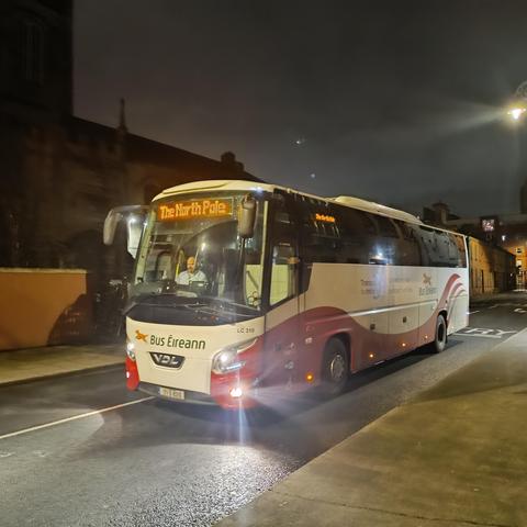 A Bus Éireann coach on a city street, displaying "The North Pole" as its destination.