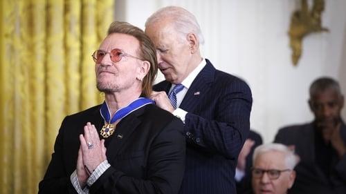Bono getting a medal from Joe Biden
