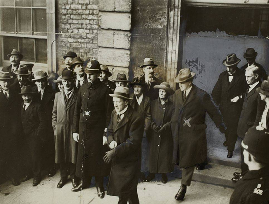Michael Collins ‘bouncing’ out through the Chief Secretary’s door after the Handover preceded by Kevin O’Higgins. (Courtesy of the National Library of Ireland).