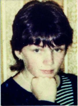Head shot of Ann Lovett with her chin on her fist.