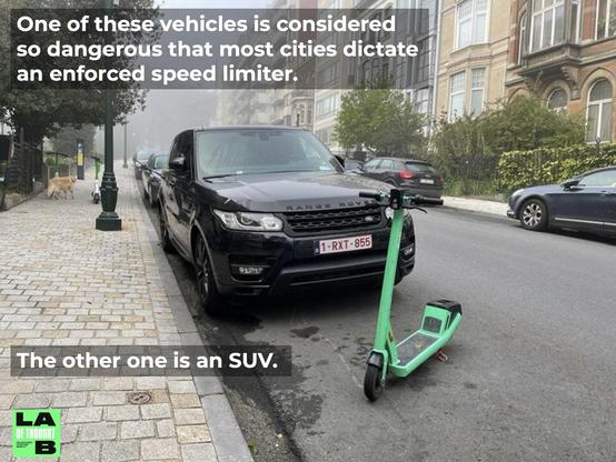 Picture of a street in a city. Cars parking at the rim. Next to the viewer is a very big black ugly SUV. In front of it a green for hire e-scooter.

Upper caption: "One of these vehicles is considered so dangerous that most cities dictate an enforced speed limiter.

Lower caption: "The other one is an SUV"
