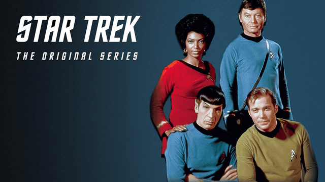 Star Trek The original series crew picture against a blue background that fades from dark black on the left to light blue on the right. 

Uhuru and Bones are standing behind Spock and Kirk who appear to be sitting in the foreground on the right of the picture. 