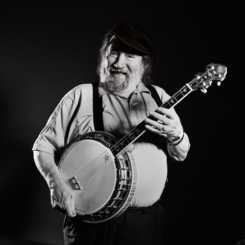 Barney McKenna holding a banjo.