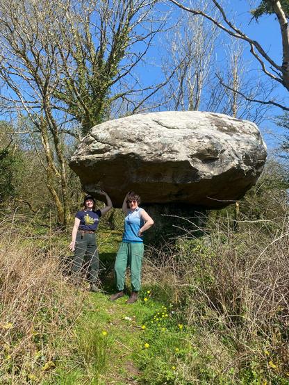 Me (right) and my sis posing in front of gortagas stone, a precarious balancing stone left by melting glaciers, in the shape of a mushroom. Blue skies and sunshine, we're delighted with ourselves for finding it.