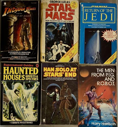 A collection of six vintage paperback books, including titles related to "Indiana Jones and the Temple of Doom," "Star Wars," "Return of the Jedi," "Han Solo at Stars' End," and "The Men from P.I.G. and R.O.B.O.T.
