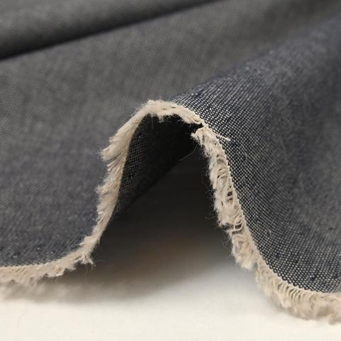 Oxford fabric in a navy, showing the edge of fabric and ecru weft