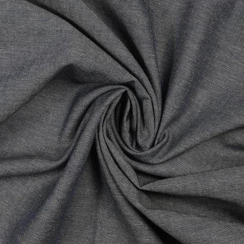 Oxford fabric in navy, looking muted due to ecru weft, shot from the top with a swirl in the fabric, showing the subtle colour changes caused by the weave.