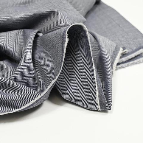 Same fabric, more brightly lit, laid out on white background. Showing the white weft edge and underside, to help confirm it's a jacquard weave and not a print.
