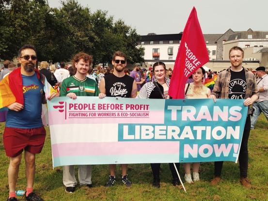 PBP Galway activists standing behind a banner saying "Trans Liberation Now!"
