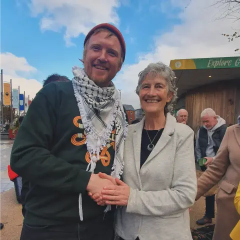 Denman shaking hands with Catherine Connolly
