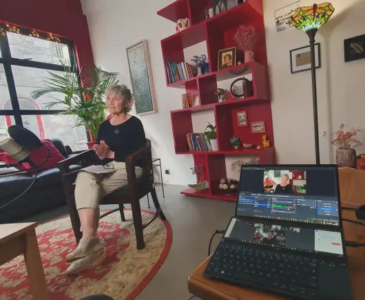 Catherine Connolly in her constituency office with camera, lights, and mic setup