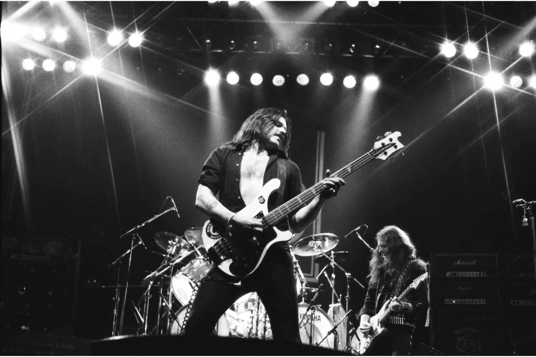 A black and white image of Lemmy on stage with Motörhead