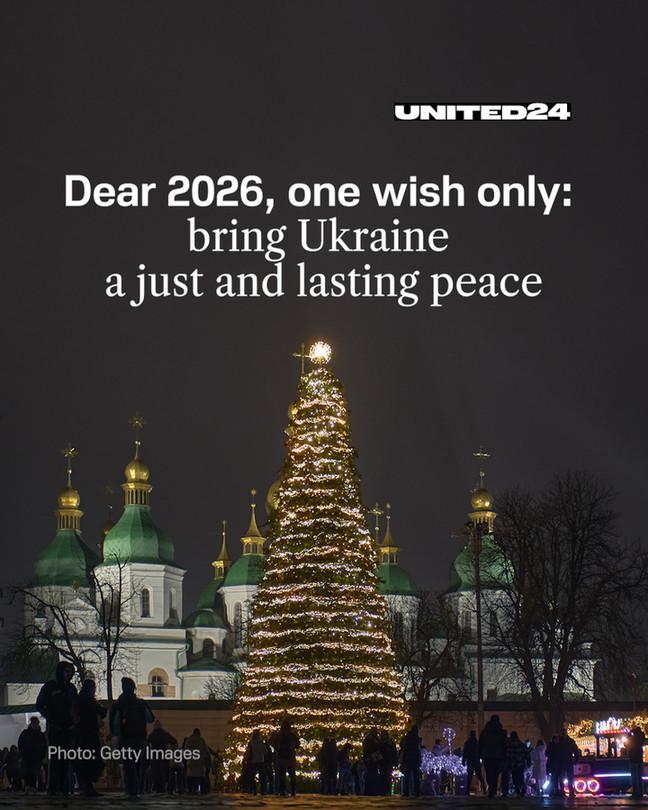 A beautifully lit Christmas tree stands at night in front of iconic golden-domed buildings, with a heartfelt message: "Dear 2026, one wish only: bring Ukraine a just and lasting peace." Photo by Getty Images.