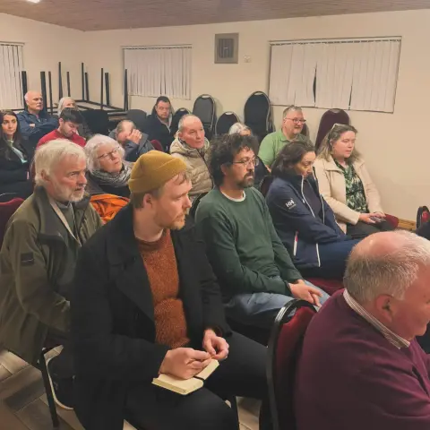 Denman Rooke in the Maam Community Centre for a public meeting