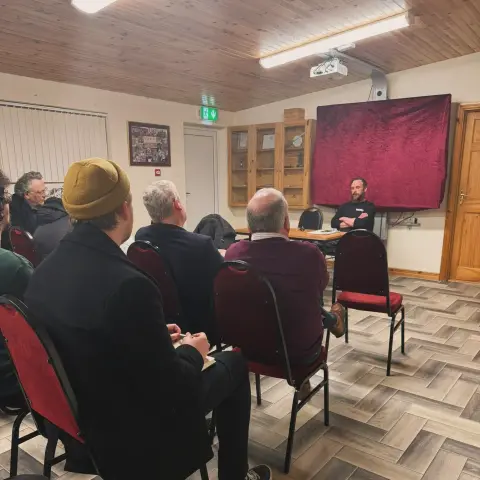 Denman Rooke in the Maam Community Centre for a public meeting