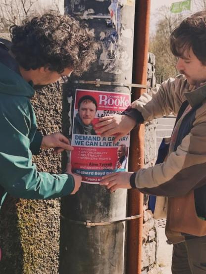 Galway PBP members putting up a poster