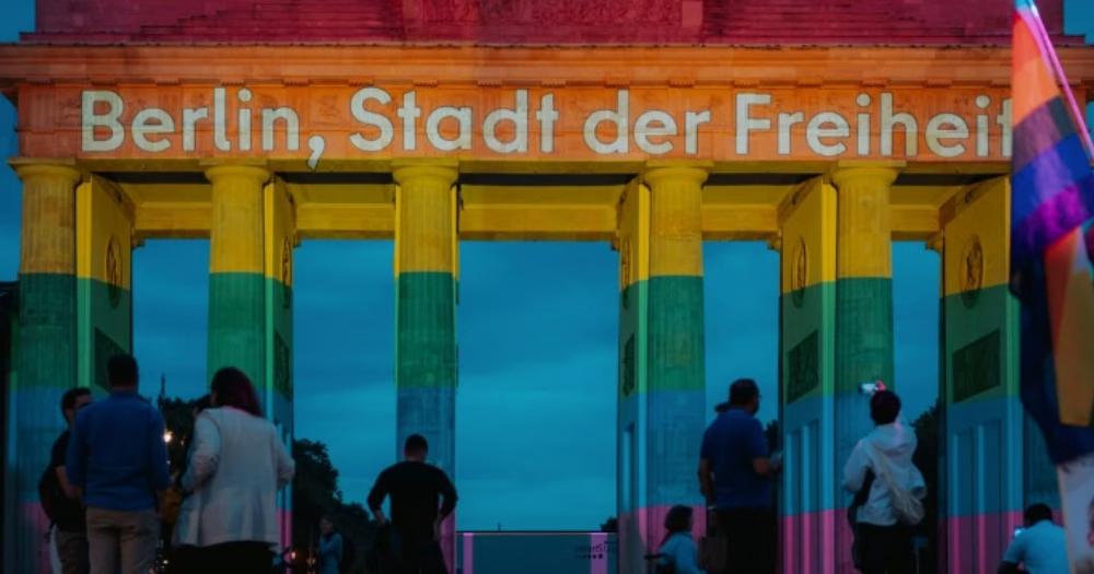 The Brandenburg Gate lit up in rainbow colours at the vigil for victims of the Berlin Pride attack.