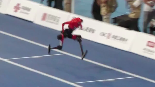 Robot at the World Humanoid Robot Games running, tripping and its leg breaking off.