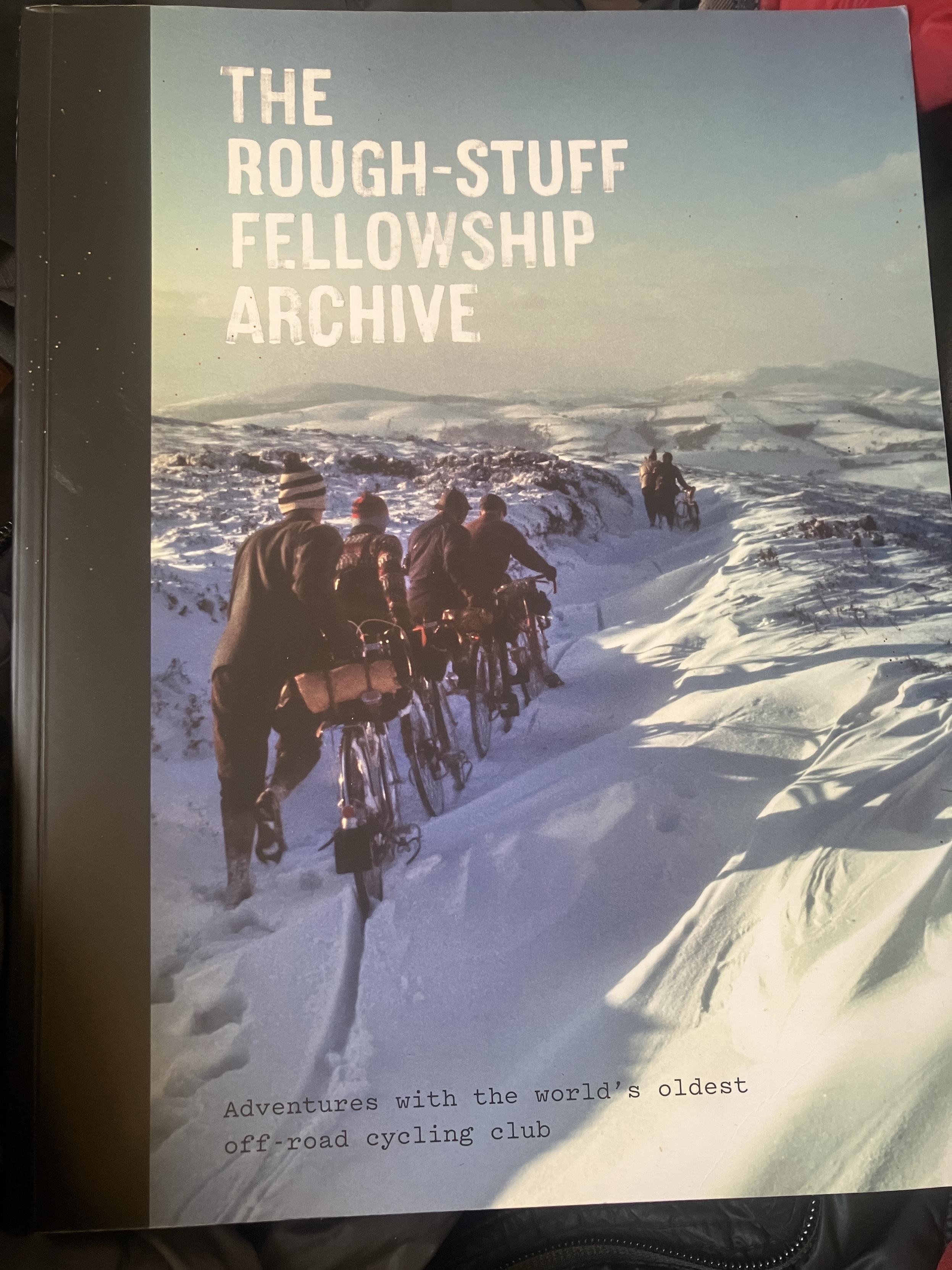 Front cover of the book: The Rough-Stuff Fellowship Archive. Adventure with the world’s oldest off road cycling club.

The cover image is a line of cyclist pushing their bikes through a snowy landscape.