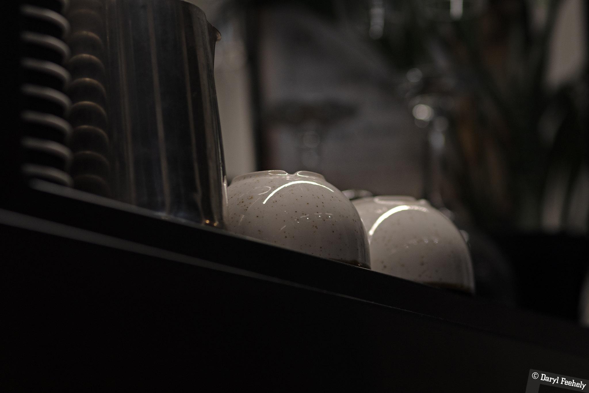 Light reflecting on an upside-down cup making it look like a grumpy toad.
