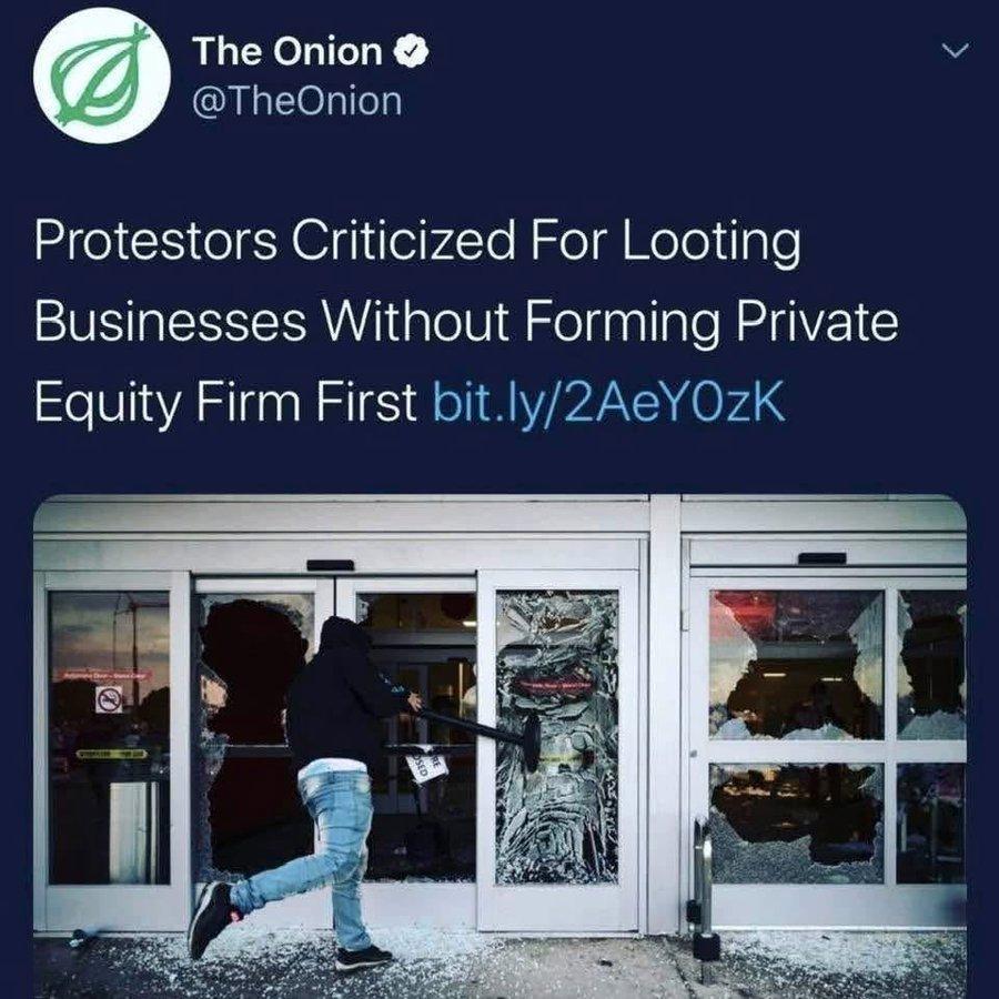 A screenshot of a tweet from The Onion ([@]TheOnion) positioned above a photograph. The tweet text reads, "Protestors Criticized For Looting Businesses Without Forming Private Equity Firm First bit.ly/2AeY0zK". The photograph depicts a person in a dark hooded sweatshirt and blue jeans using a sledgehammer to strike a glass door. Shattered glass is visible on the ground and within the door frame.