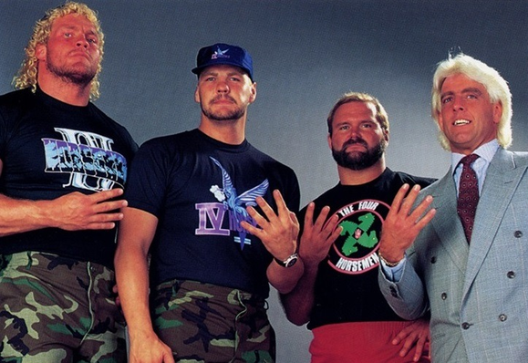 The Four Horsemen 
From Left to Right: Sid Vicious, Barry Windham, Arn Anderson, Ric Flair

They are holding up their hands with their four finger extended and their thumb hidden.