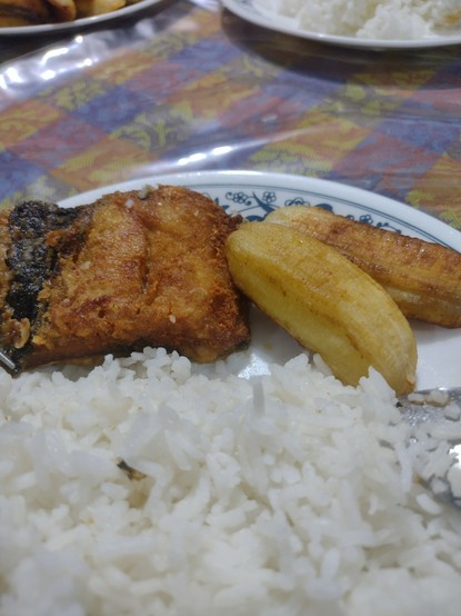 A plate of fried milkfish, fried saba banana, and steamed rice.