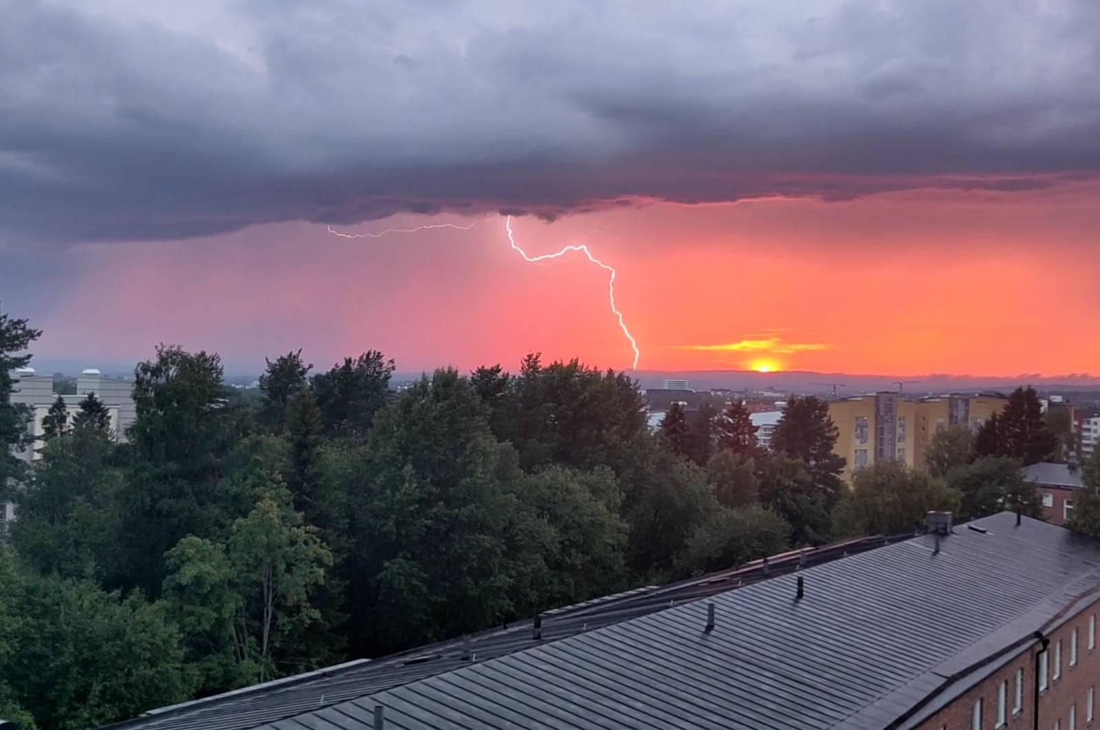 A sundown in Umeå, Sweden with heavy gray clouds and a flash!
