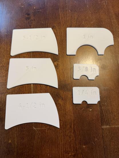 A photo of six radius gauges that were 3D printed in white PLA.