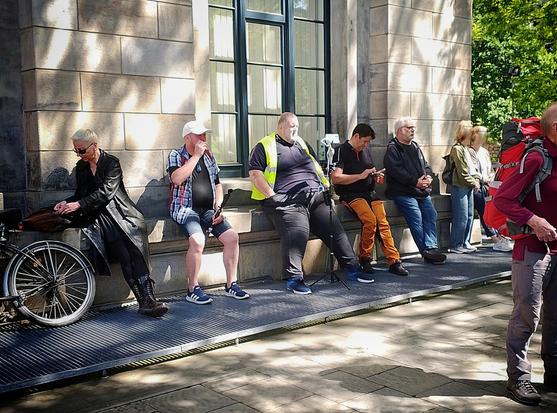 Einige Personen, auf dem Opernplatz, Mann in gelber Weste filmt dauerhaft unsere demokratische Demonstration.