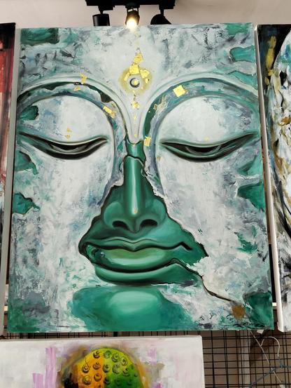 a  painting  of  a close-up of a large face, the skin is a metallic aqua color, white mineral clouds passing over it, the eyes of the face are low in meditation