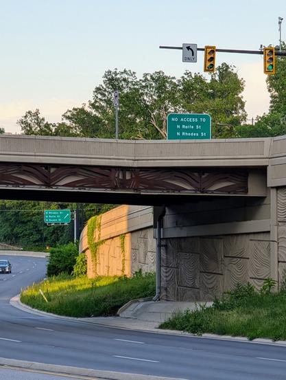 The sign visible at the top of the on-ramp to U.S. 50 eastbound from N. Courthouse Road tells drivers not to try to take the next offramp, with its exit sign visible just down the highway. The evening sun lights up the scene.