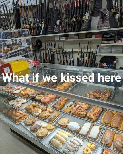 This is a meme. The image shows a display case in a bakery filled with various pastries and donuts. Above the display case, there is a humorous text overlay that reads, "What if we kissed here." This meme plays on the idea of romantic or intimate moments in unexpected or mundane settings, juxtaposing the sweet treats with a playful suggestion of affection, creating a lighthearted and amusing tone.
