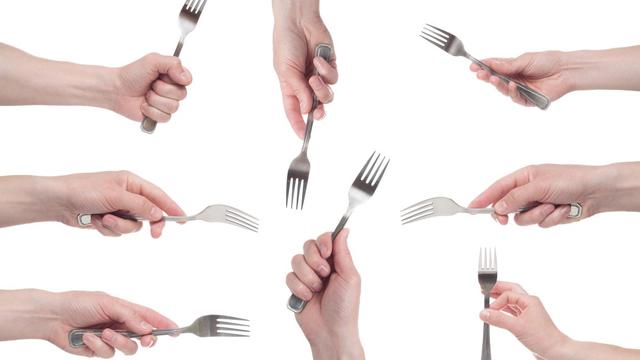 Multiple forks being held by hands
