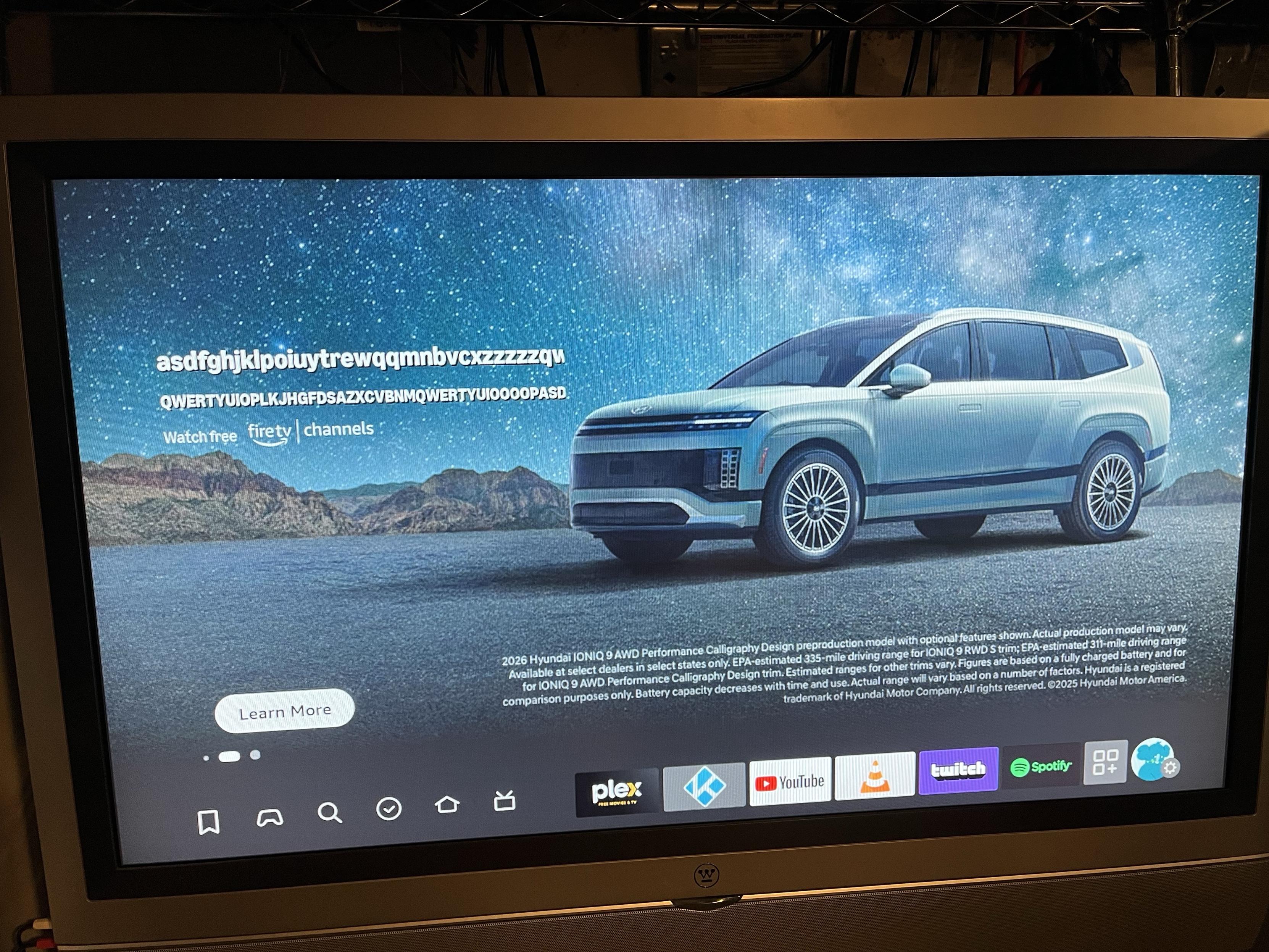 A digital display showcasing a Hyundai vehicle against a starry night backdrop, with various random faceroll text