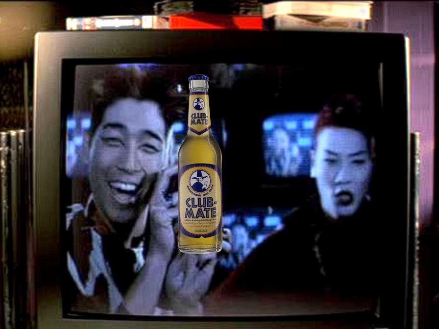 A still from the 1995 Hackers movie showing the characters Razor and Blade. Originally they held up a can of Jolt Cola. It has been photoshopped so that they are holding up a bottle of Club Mate.