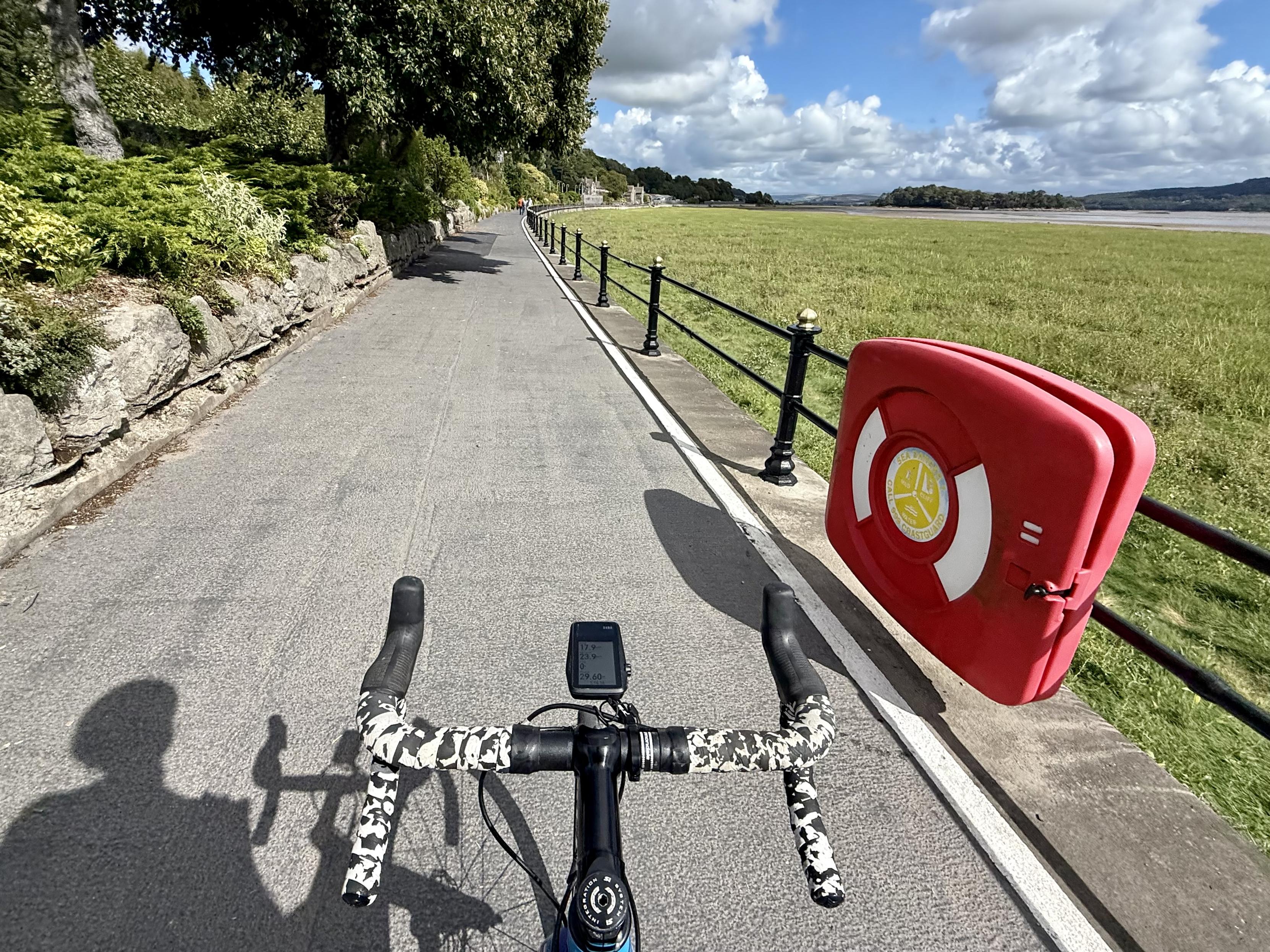 View down a prom from behind handlebars of a bike