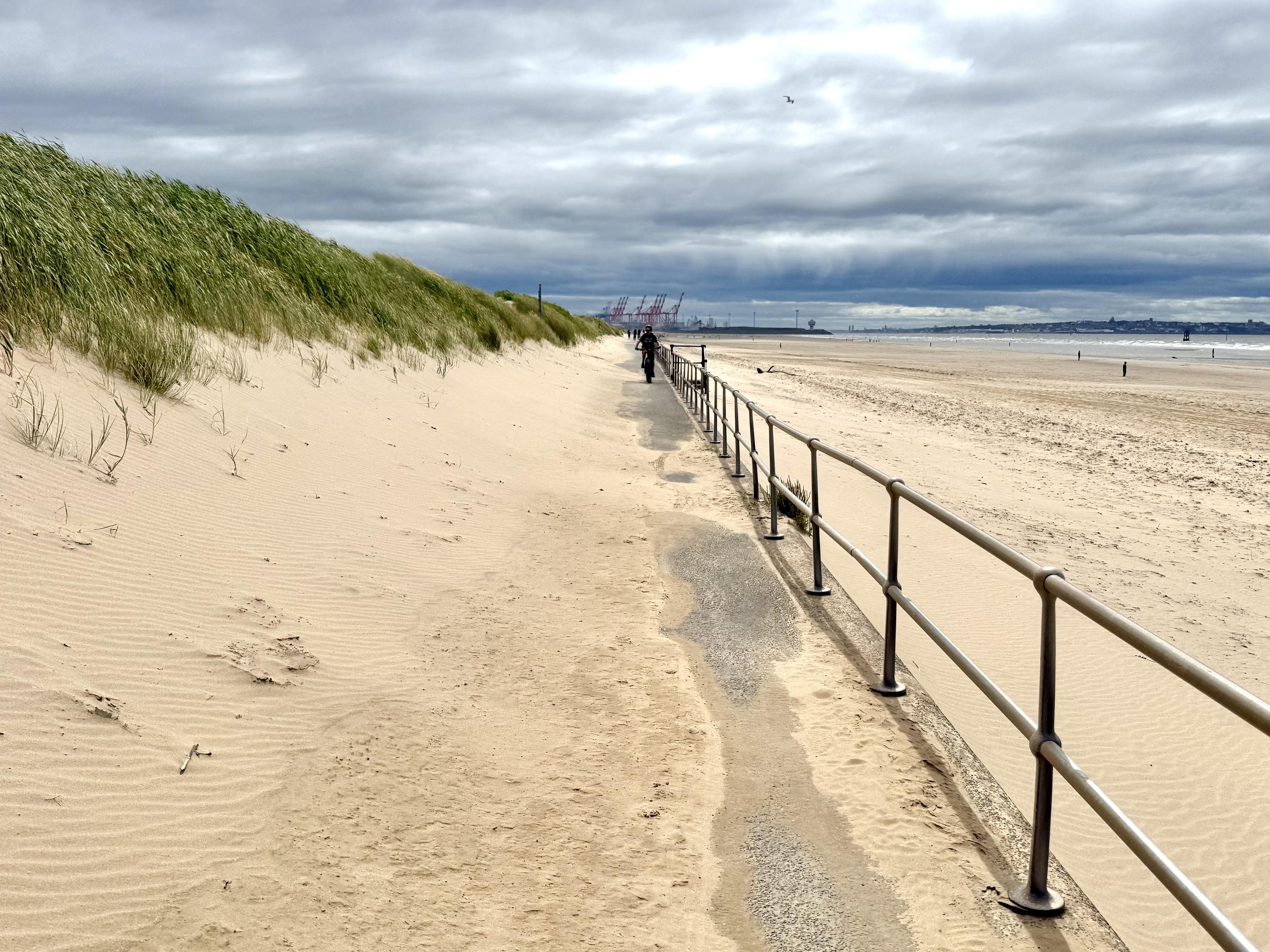 Cyclist on a sandy prom